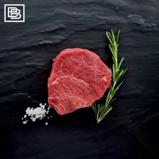 Grass Fed Tenderloin Filet Mignon Steak With Pinch of Sea Salt and Sprig of Rosemary