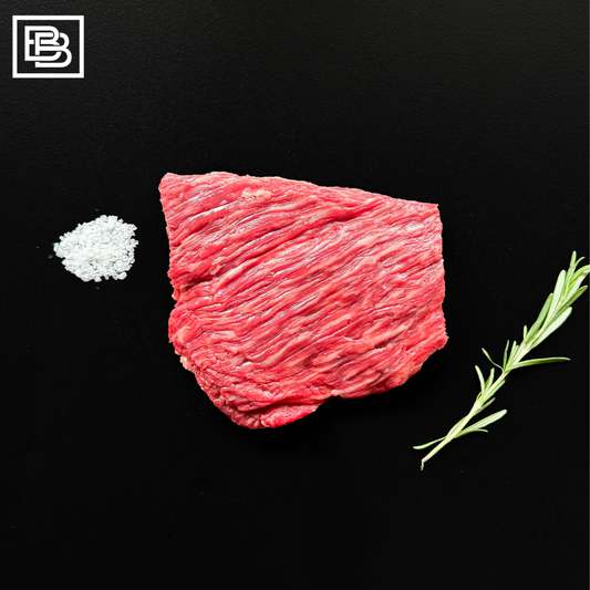 Stone Axe Full Blood Wagyu Bavette on a Black Surface with salt and rosemary